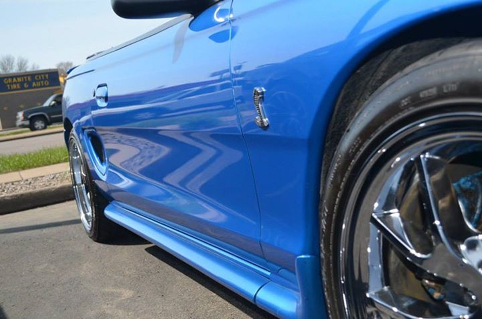 Blue sports car parked on street