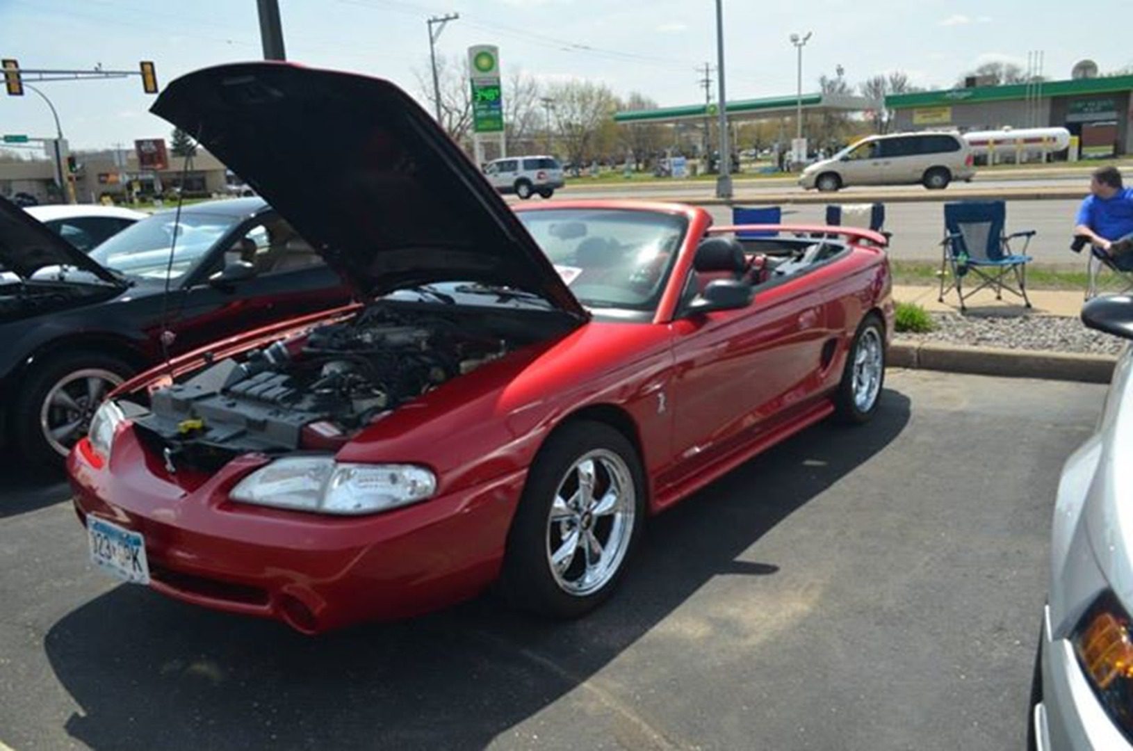 Red convertible car with hood open