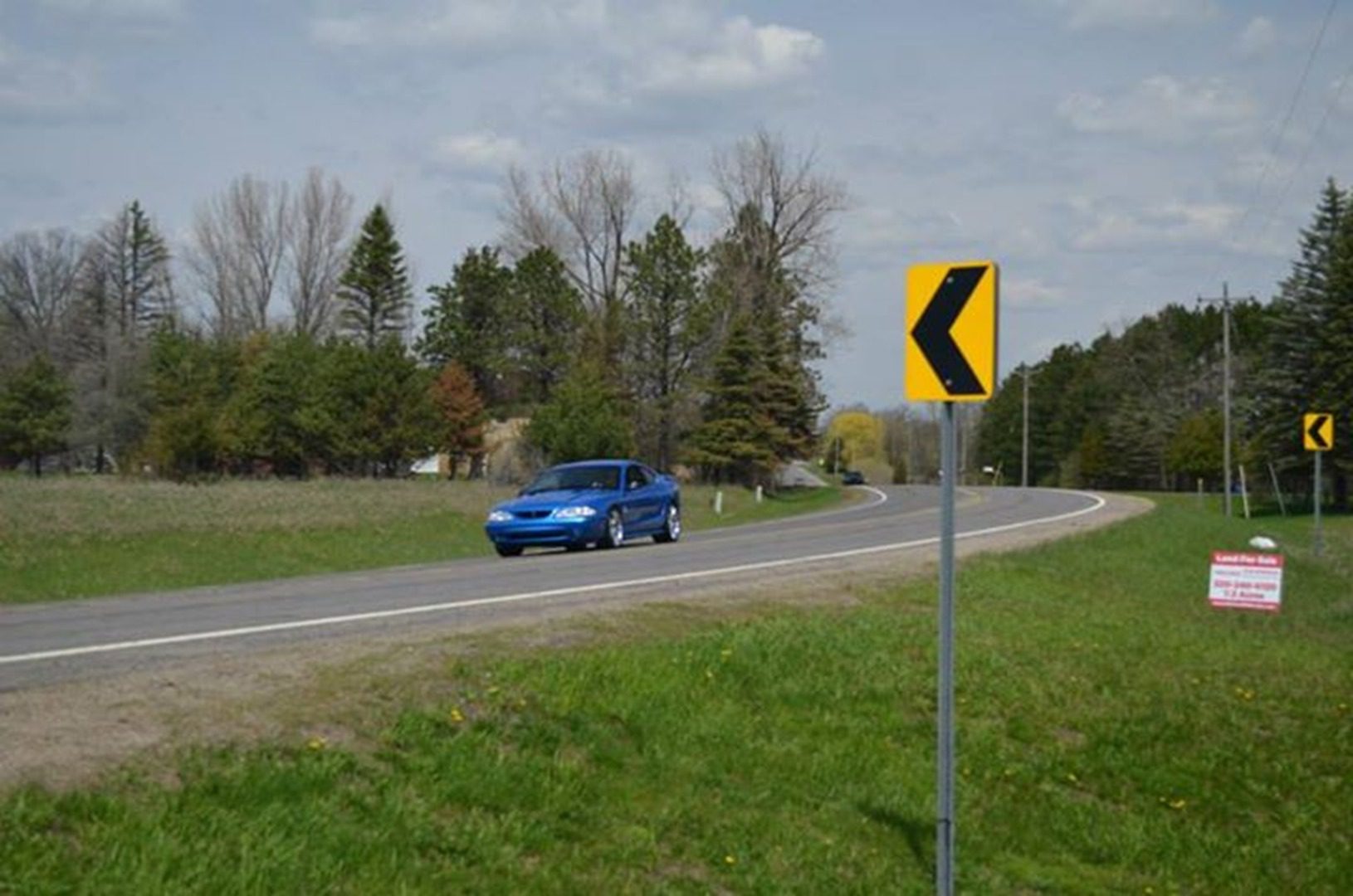 Curved road with yellow arrow sign