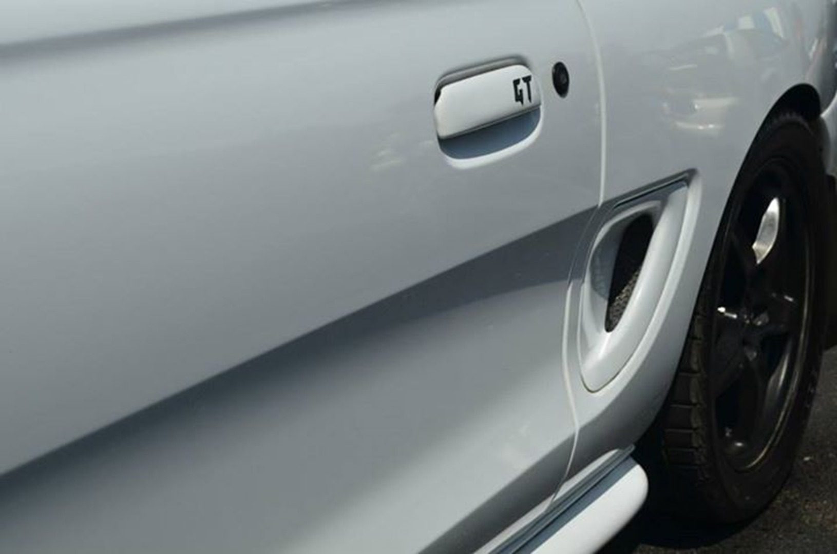 White car door with GT badge