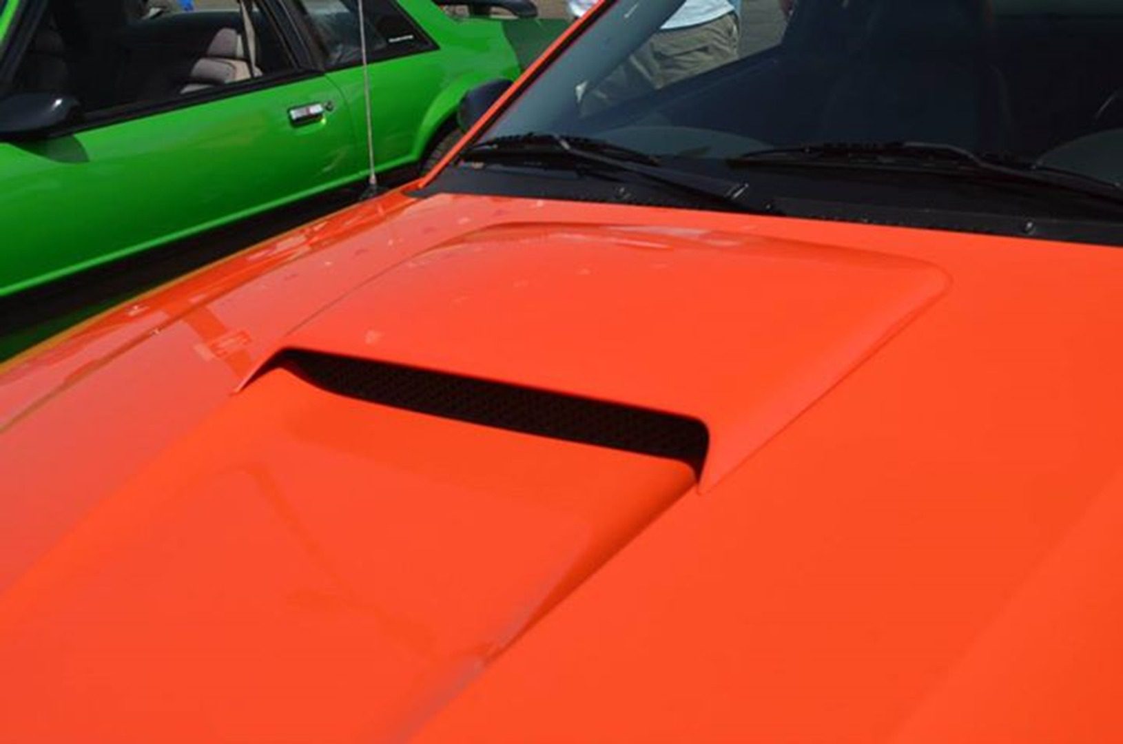 Close-up of orange car's hood vent