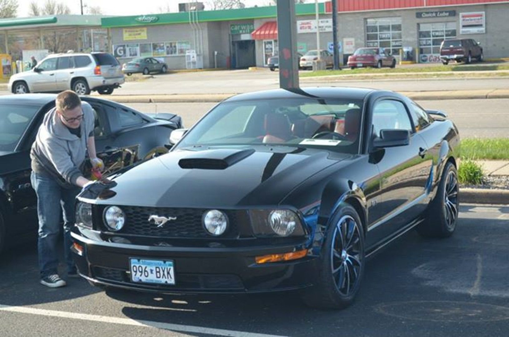 Man cleaning black sports car