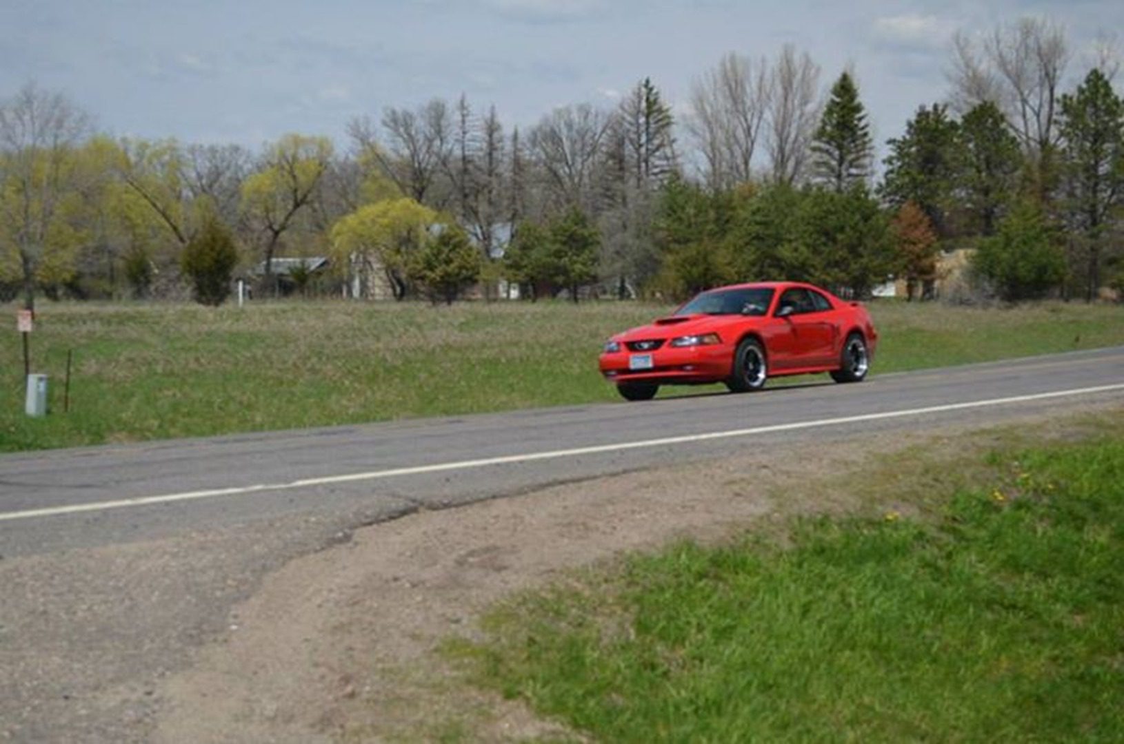 Red sports car on rural road