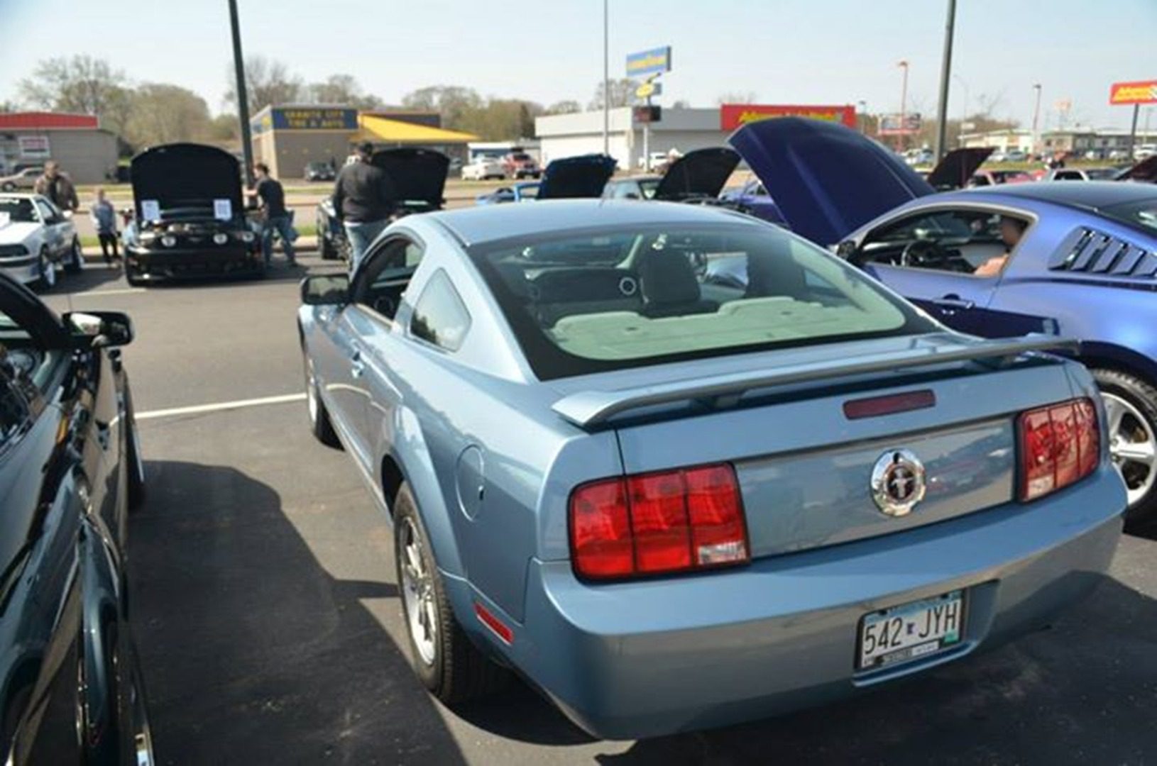 Cars with open hoods in parking lot