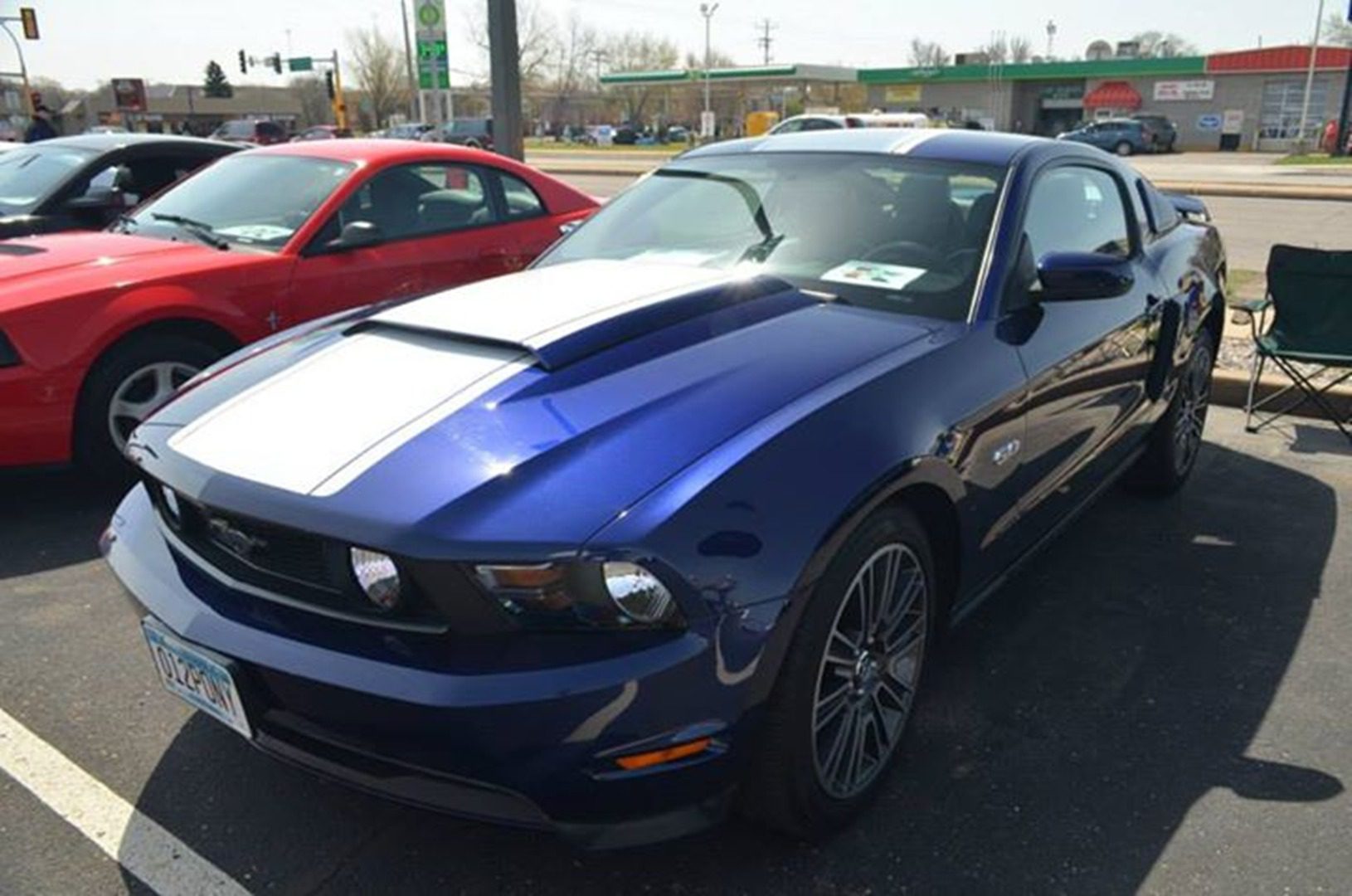 Blue sports car with white racing stripes