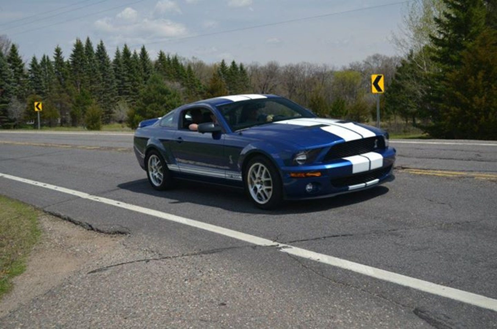 Blue sports car on a curved road