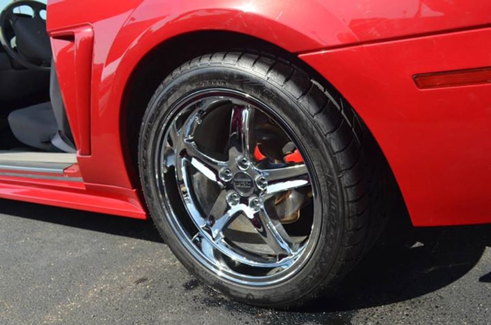 Polished rim on red vehicle