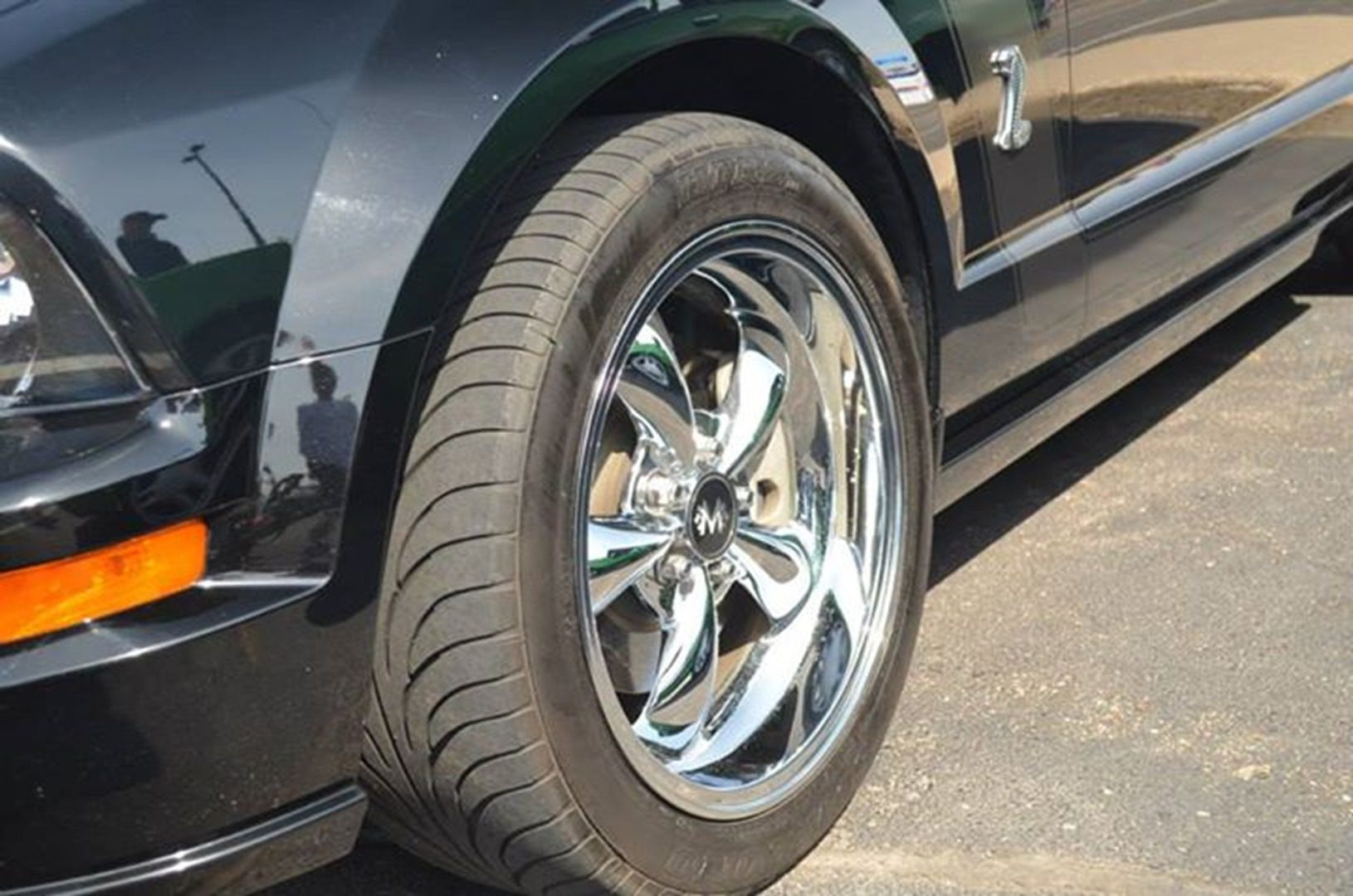 Black car with polished chrome rim